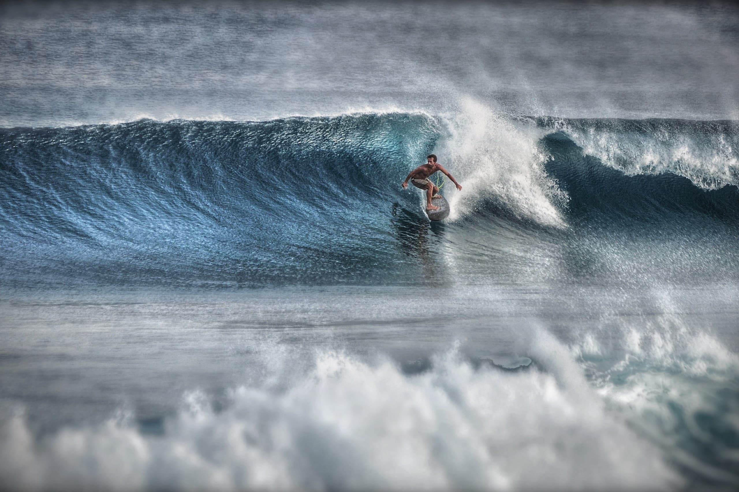 Glassy ocean conditions during an epic surfing day in the Maldives with perfect swell lines