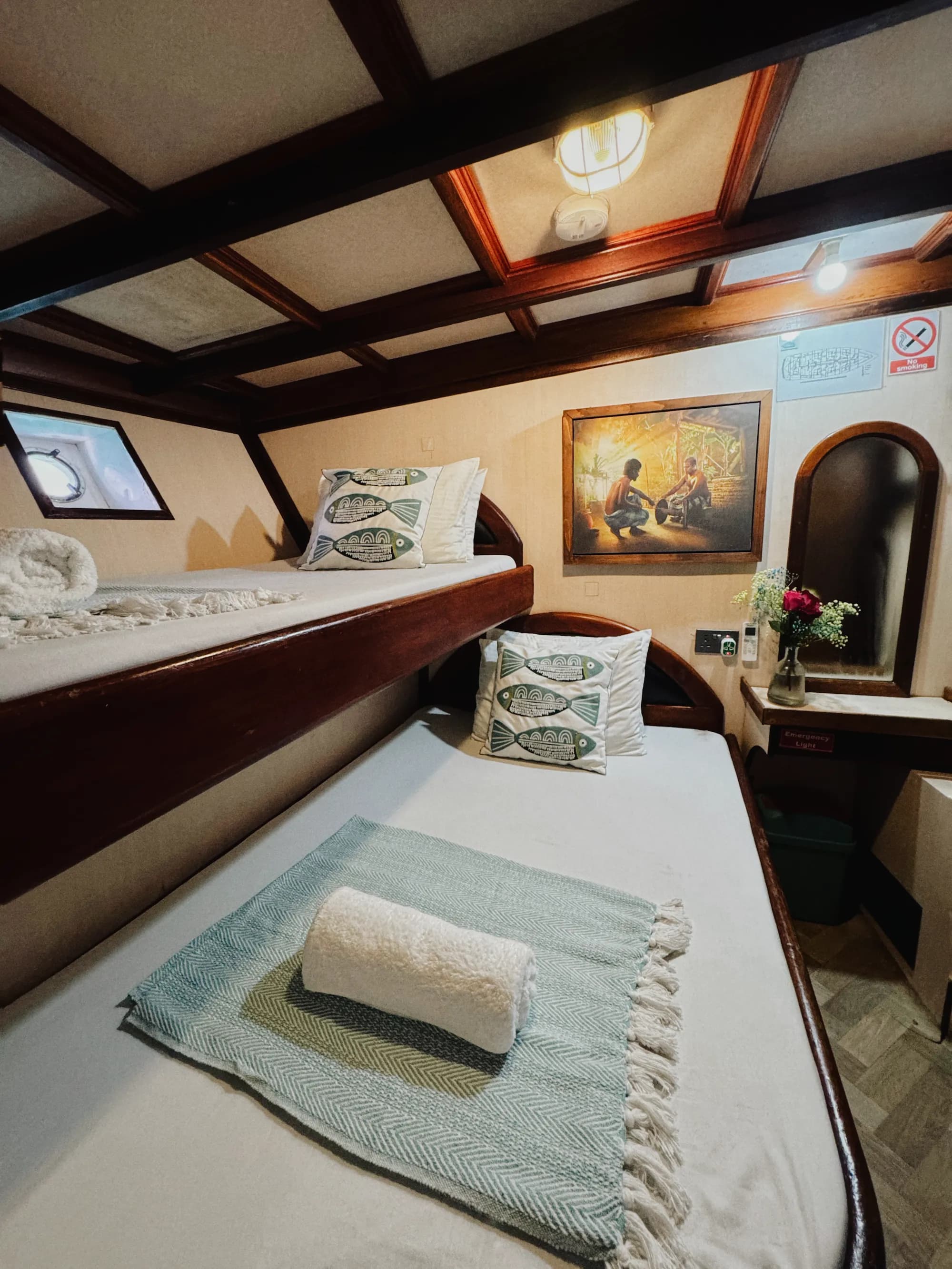 Maavahi Maldives liveaboard cabin with bunk beds and wooden interior