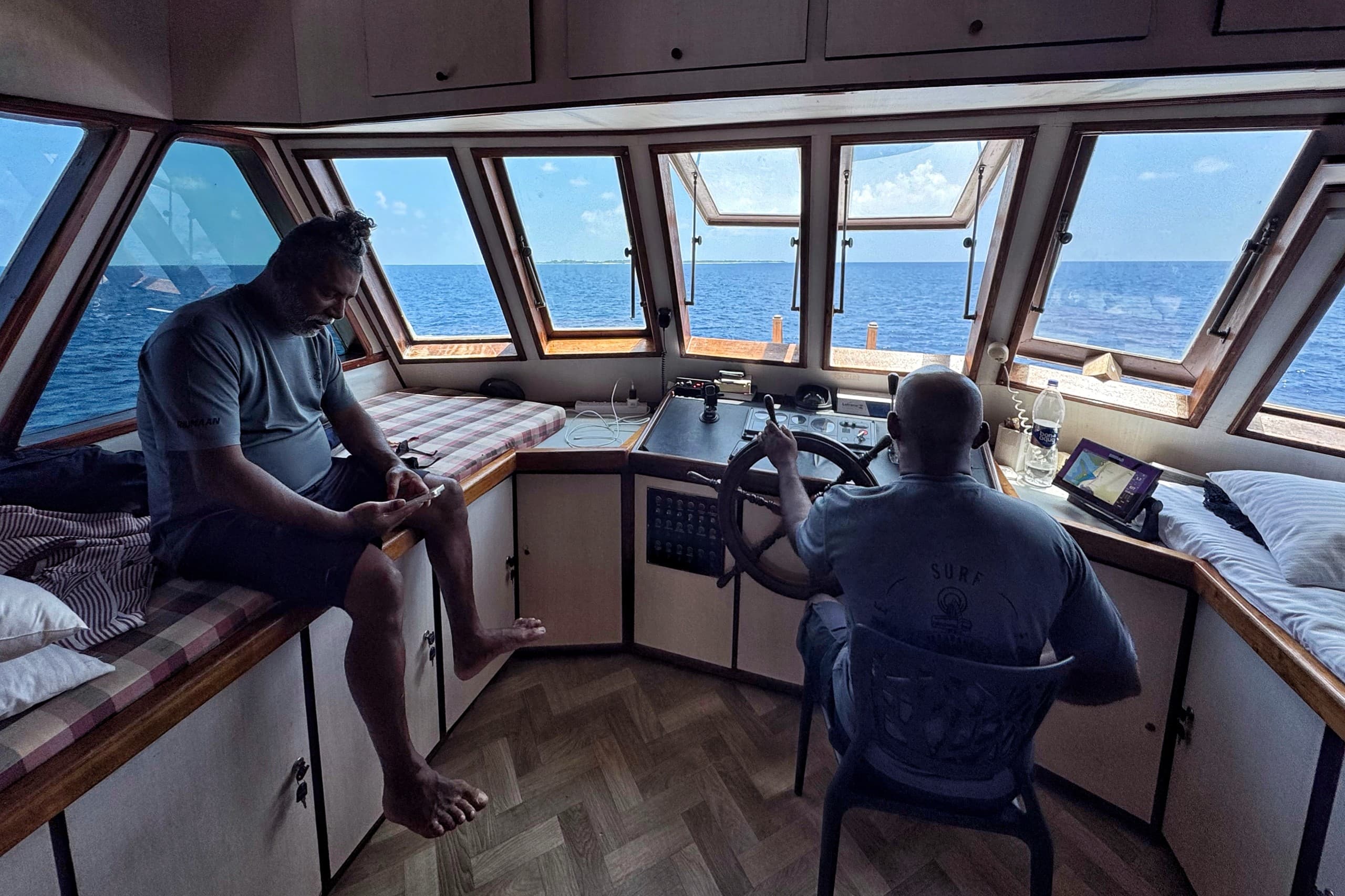 Maavahi Maldives liveaboard bridge with crew navigating in the Indian Ocean