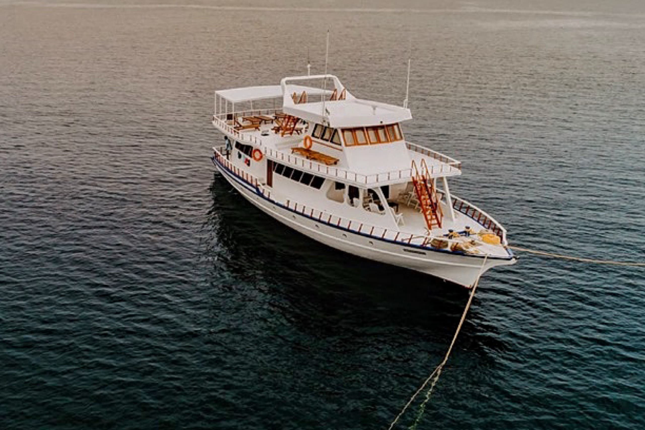 Maavahi Maldives liveaboard charter boat anchored in open ocean, aerial drone view