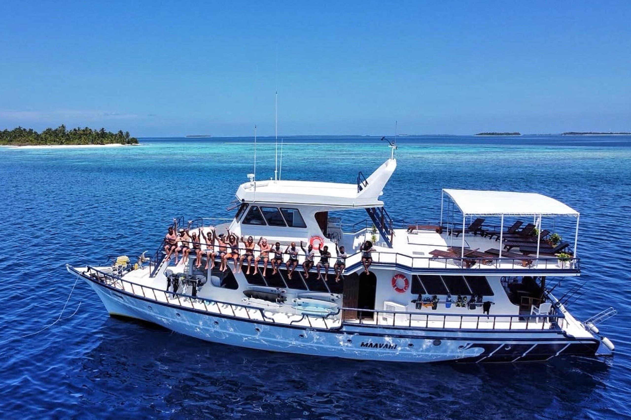 Drone shot of guests group on Maavahi liveaboard boat in Maldives during a charter trip