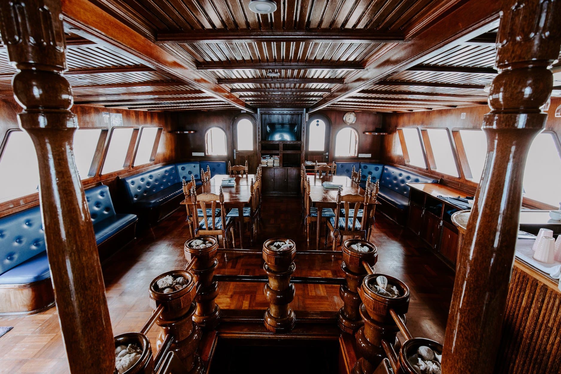 Indoor saloon and dining layout on Maavahi Maldives liveaboard with shared seating area