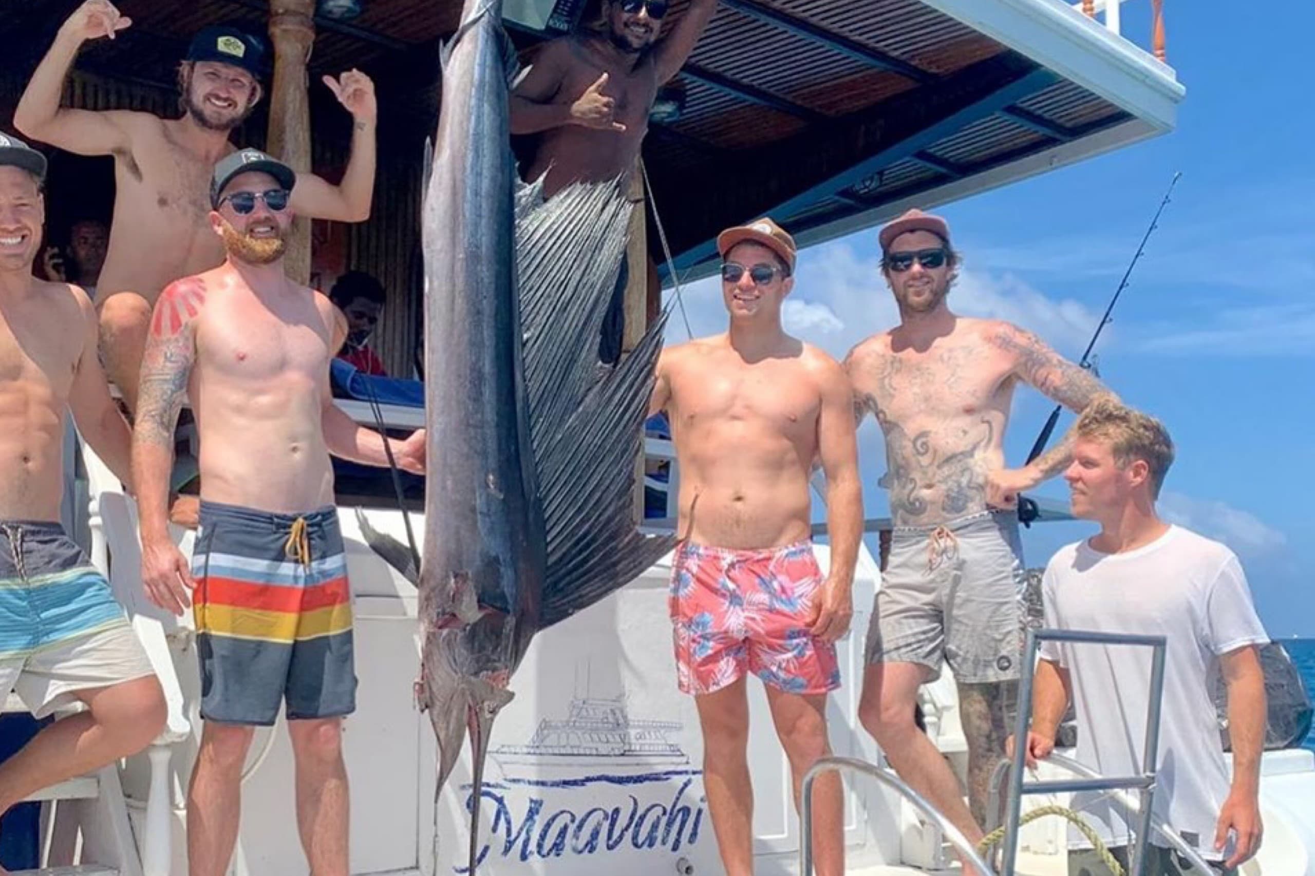 Big game fishing in Maldives with Maavahi crew and guests holding a sailfish on boat